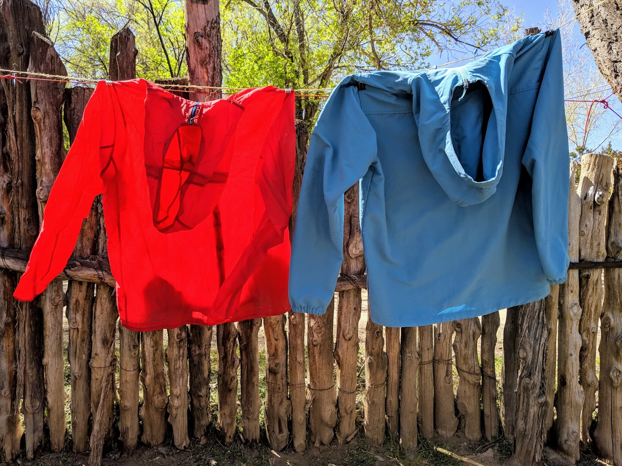 Close-up comparison of a lightweight 1.2-ounce single-layer nylon jacket next to a heavier 4.5-ounce fabric.