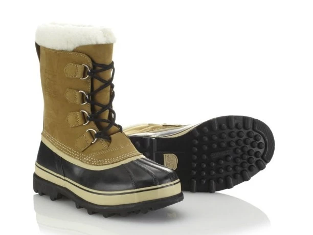 A person wearing Sorel Caribou winter boots strapped into snowshoe bindings.