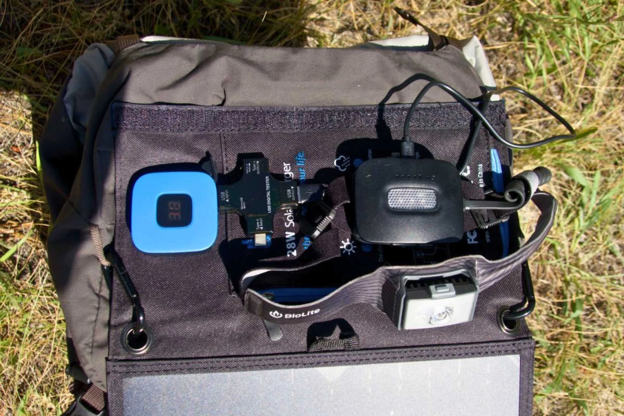 Two ultralight 10k power banks positioned next to a lightweight trekking setup.