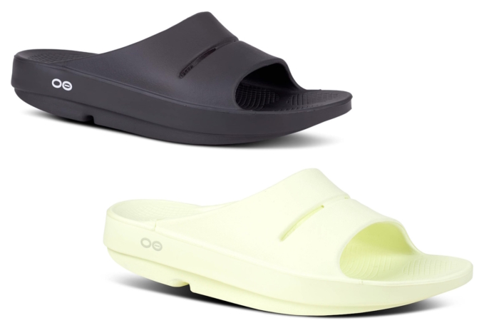 Close-up of black Oofos Ooahh Slide sandals with a thick foam sole designed for arch support.