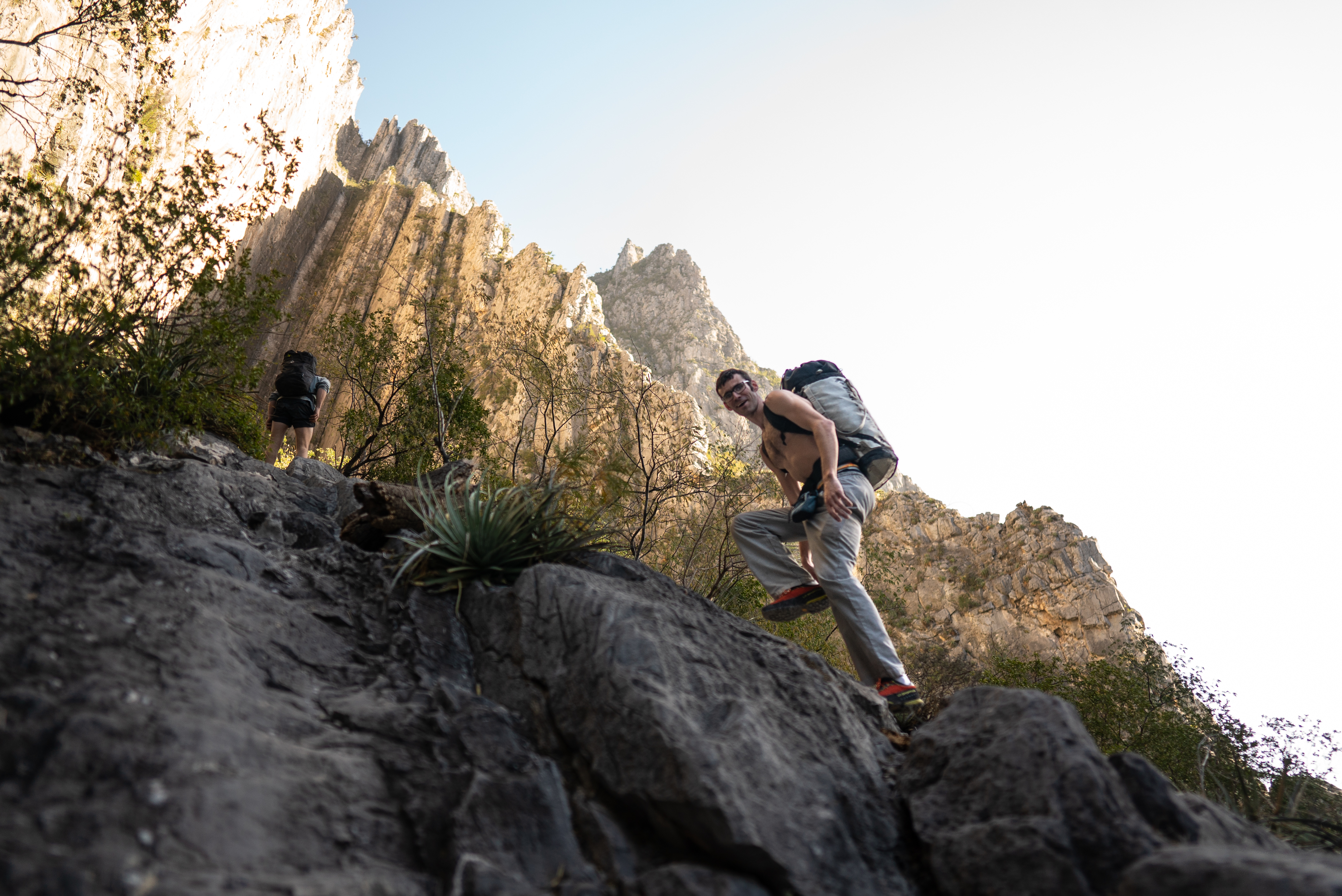 Close-up of an approach shoe providing grip on a steep rock face.