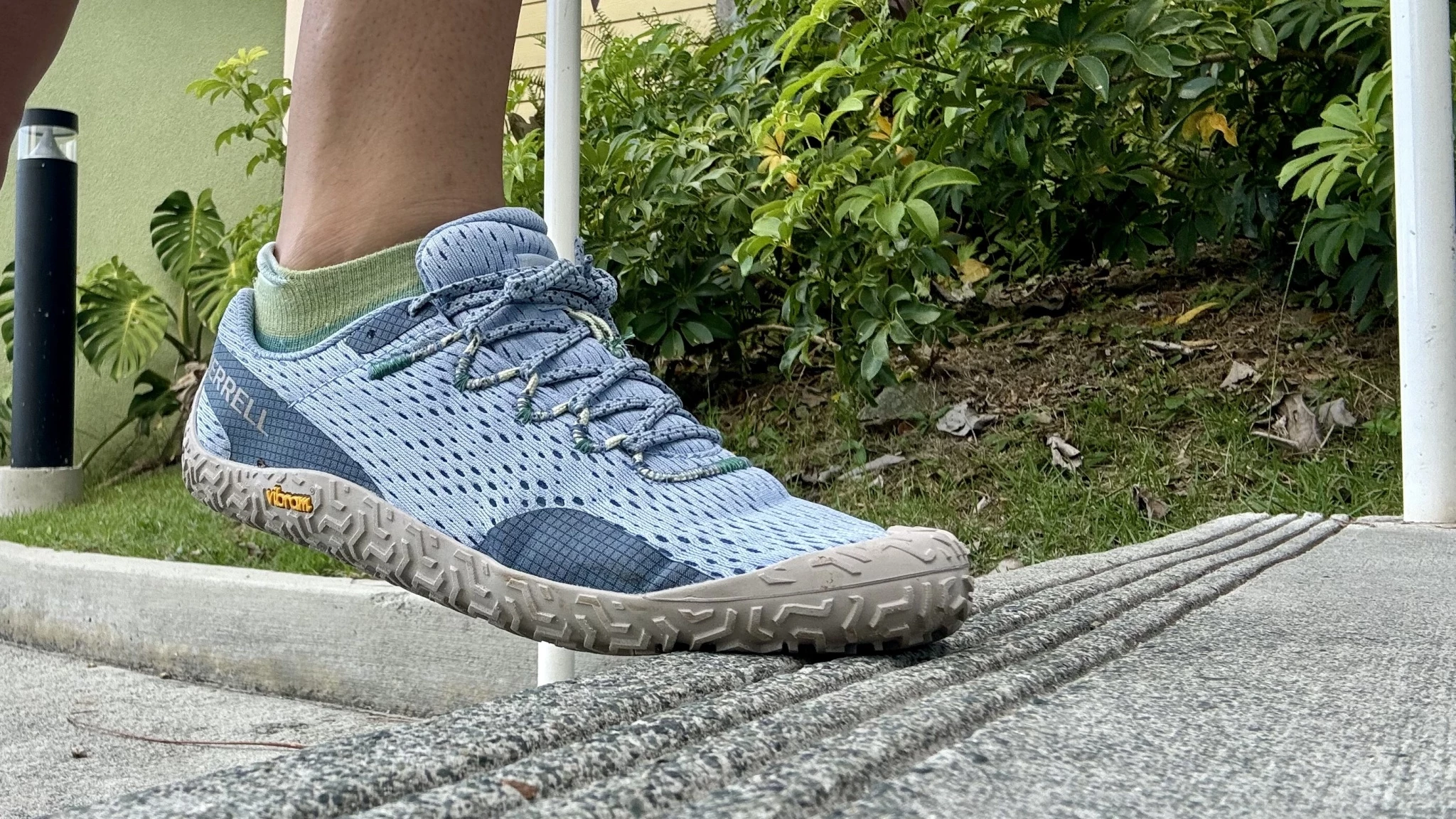 Side profile of the lightweight Merrell Vapor Glove showing the thin Vibram outsole.