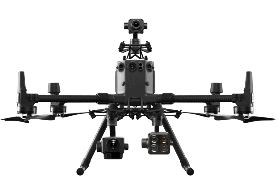A large enterprise drone, the DJI Matrice 300 RTK, on a tripod in a rocky environment.