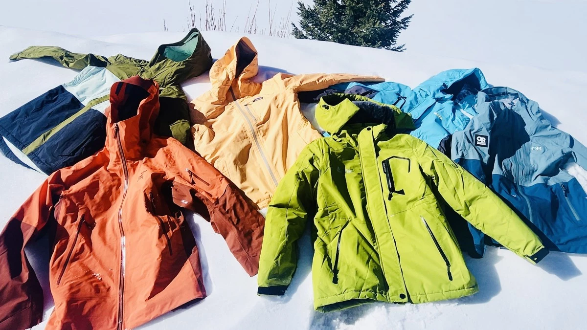 A diverse lineup of various women's ski jackets in different colors and styles.