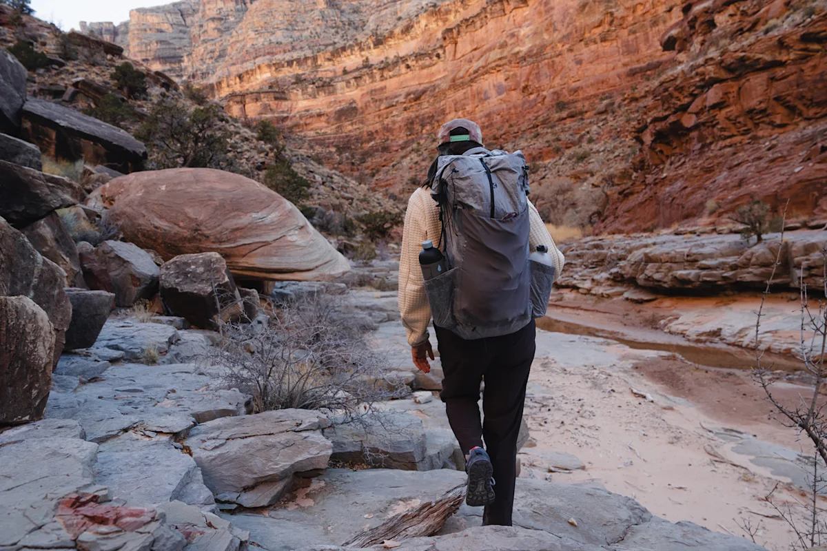 Hiker wearing the Mirage 40 in a rocky canyon setting.