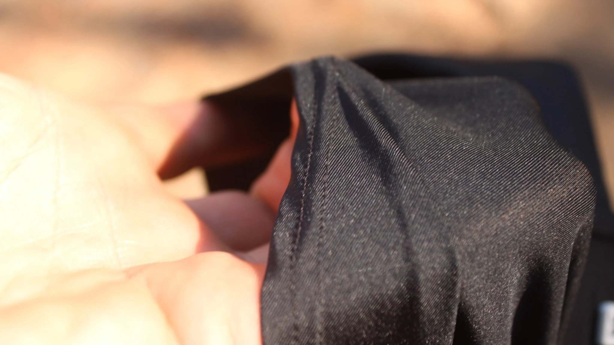 Macro view of flatlock seams and smooth liner fabric on high-end running shorts.