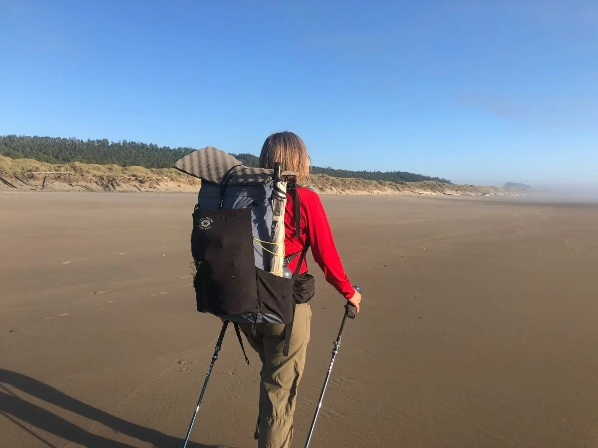 Detailed layout of lightweight backpacking gear, including a backpack, tent, and kitchen kit.