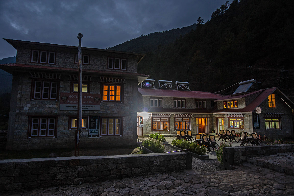 A typical stone and wood teahouse structure nestled in the Himalayan mountains.