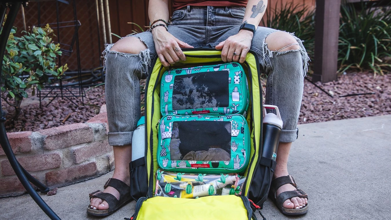 A backpack opened flat like a suitcase to show the organized gear inside.