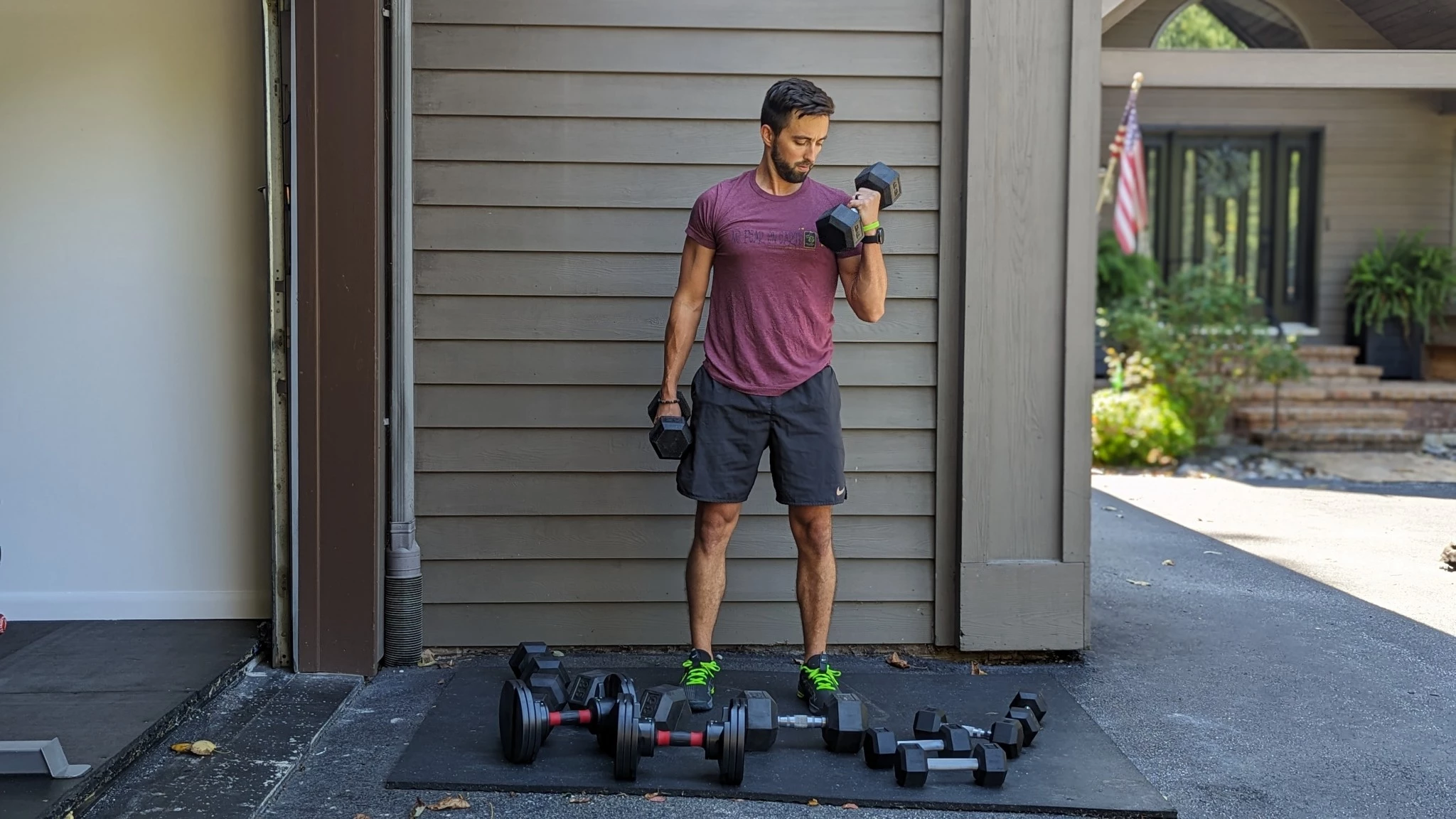Various dumbbells being tested side-by-side in a gym setting.