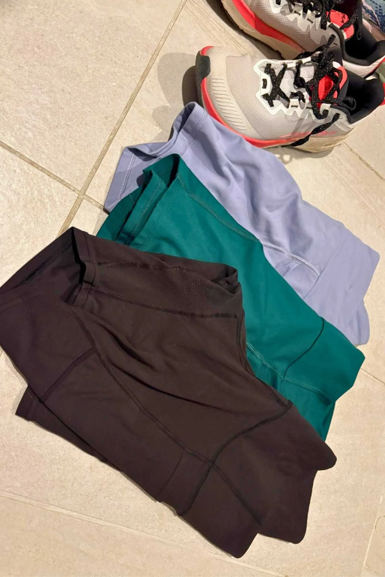 Comparison photo showing the pockets and fabric of black Maipo shorts next to green Gnara and purple Kuhl shorts.