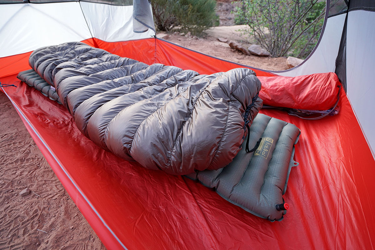 Close-up of a high-loft down sleeping bag on an orange sleeping pad.